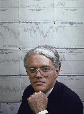 Peter Lynch in front of graph of American stock prices at Fidelity Magellan